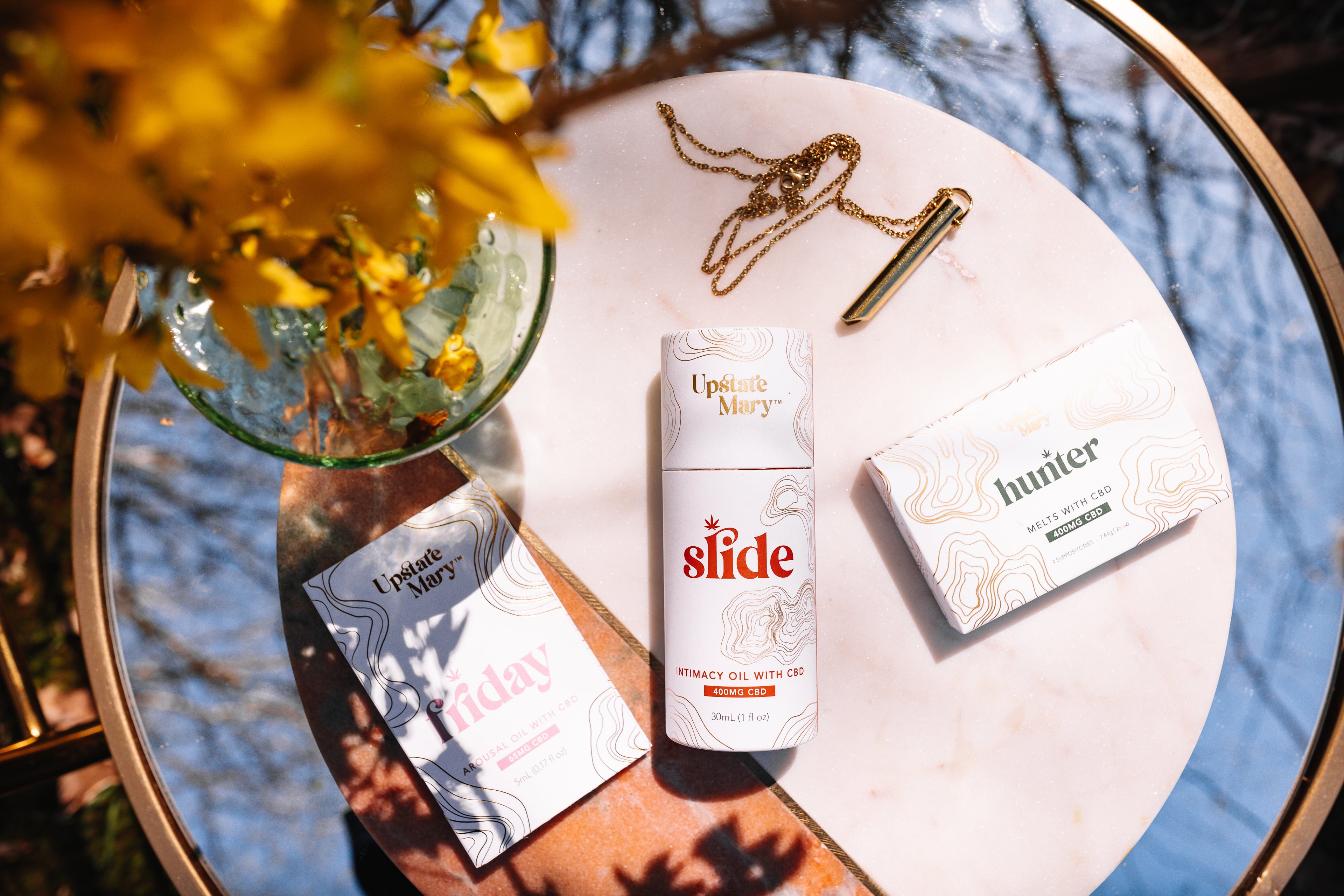 Intimacy essentials_sex oil_body_hemp_CBD on mirror display outdoors in the fall