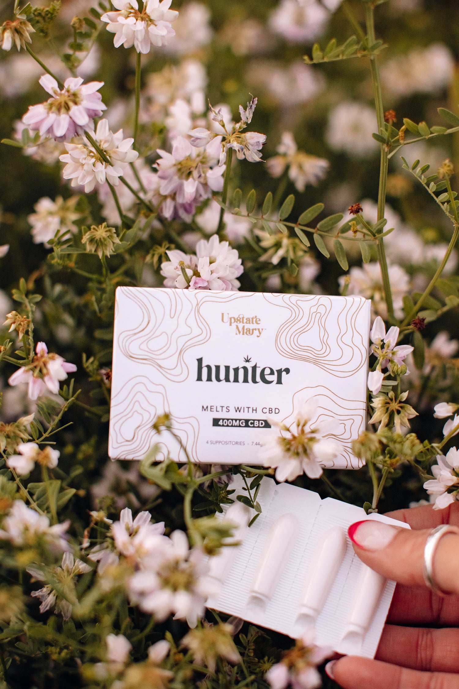 hand holding Hunter suppositories with CBD_botanicals_hemp